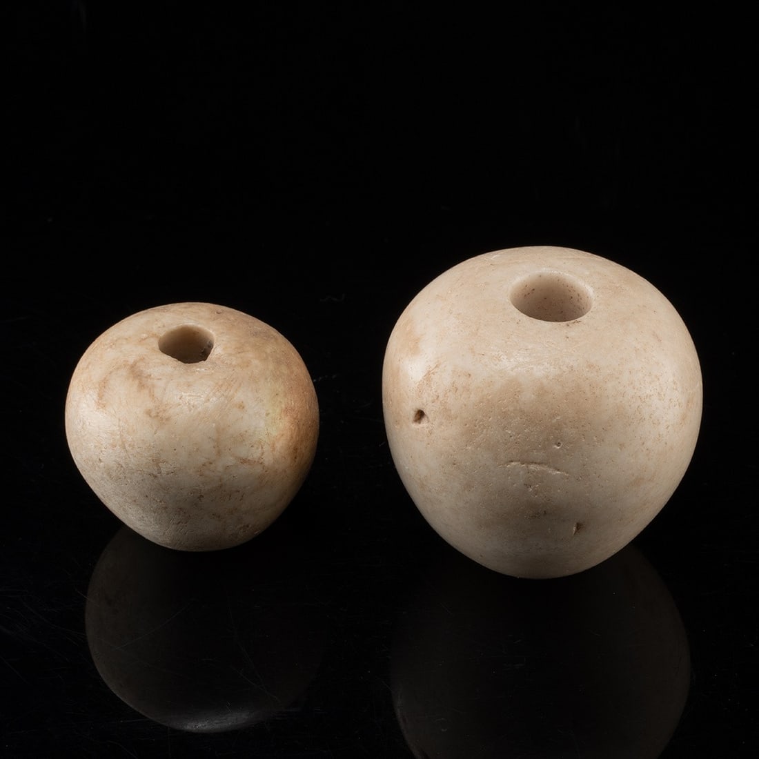 Two Egyptian Predynastic Piriform Limestone Mace Heads: North Africa, Egypt, Predynastic period, Naqada culture, ca. 4000–3100 BCE. A pair of hand-worked limestone mace heads, each cut to the piriform (pear-shaped) profile that defines late Predynast