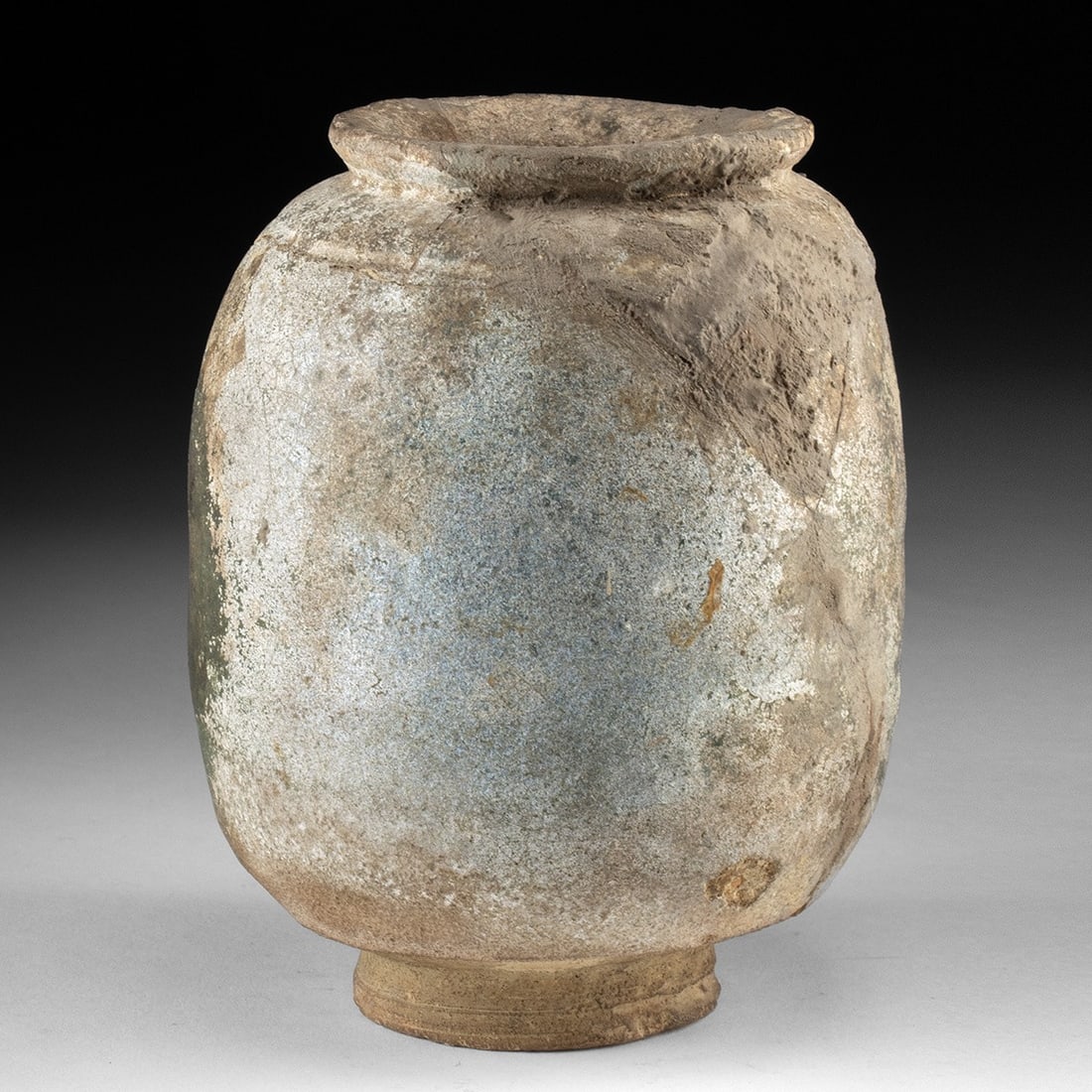 Ancient Parthian Glazed Pottery Jar - Pale Green Cylindrical Form: Ca. 200 BCE – 200 CE. Near East, Syria, Parthian, ca. 2nd century BCE to 2nd century CE. A wheel-thrown cylindrical jar enlivened by a pale turquoise green glaze that now blooms with pearly whit