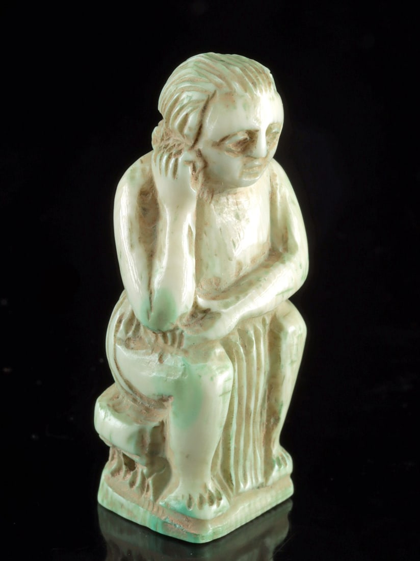 Rare Roman Ivory Figure - Youthful Seated Male: Ca. 1–300 CE. Romano-Egyptian, ca. 1st to 3rd century CE. A fabulous ivory sculpture of a youthful male figure seated in a pensive or melancholic pose, all enveloped in light blue-green glaze ty