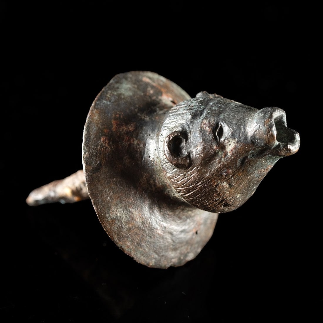 Roman Zoomorphic Furniture Attachment with Bear Head, 1st-3rd C. CE: Roman, Imperial period, ca. 1–300 CE. A bear peers out of the metal in miniature, muzzle blunt and lips parted around an open mouth, small rounded ears set back against a domed skull. The head i