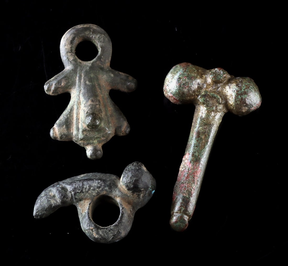 Roman Bronze Fascinum Amulets, Set of 3: Ca. 1–300 CE. Roman, Imperial period, ca. 1st to 3rd century CE. A group of three Roman fascinum amulets in bronze and leaded copper alloy, phallic in form, associated with warding off the evil 