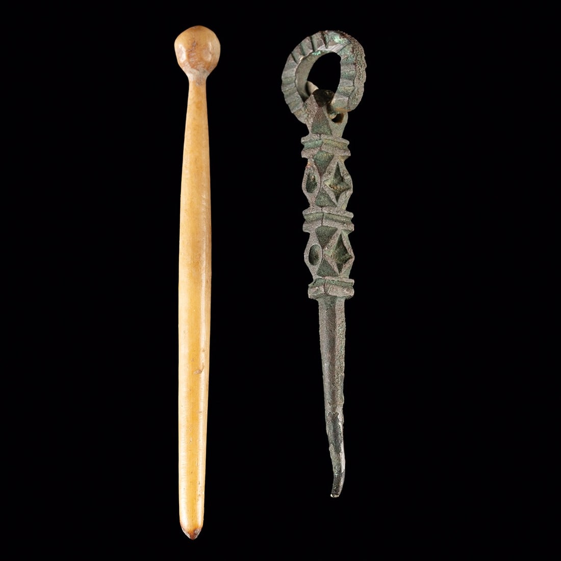 Two Roman Brass & Bone Cosmetic Implement: Roman, Imperial period, ca. 1–400 CE. A pair of small personal implements from the Roman toilet kit, both of a scale that fits comfortably between two fingers. The shorter piece is cast in leade