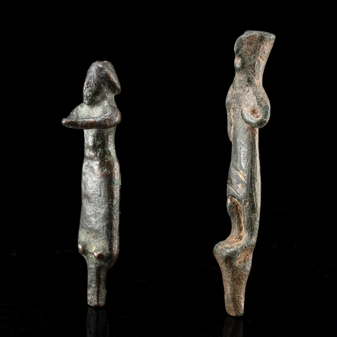 Pair of Miniature Iberian Bronze Votive Figures: Iberia, modern day Spain or P{ortugal, ca. 1000–150 BCE. A pair of diminutive cast bronze devotees, both miniature in scale and reduced to the essentials of stance and gesture. The taller wears 