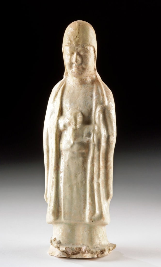 Chinese Sui-Tang Straw Glazed Mingqi Attendant Figure: Ca. 581–907 CE. East Asia, China, Sui to Tang Dynasty, ca. 581 to 907 CE. A mold-made pottery mingqi figure of a robed attendant, depicted with serene facial features and hands clasped against t