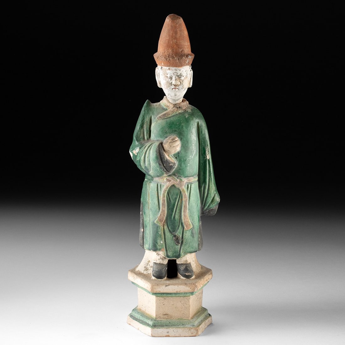 Ming Dynasty Green-Glazed Pottery Attendant Figure - Tomb Mingqi: East Asia, China, Ming Dynasty, ca. 1368–1644 CE. A standing attendant rises with quiet dignity, his long robe washed in the cool lead-green glaze that distinguishes Ming funerary sculpture. Mol