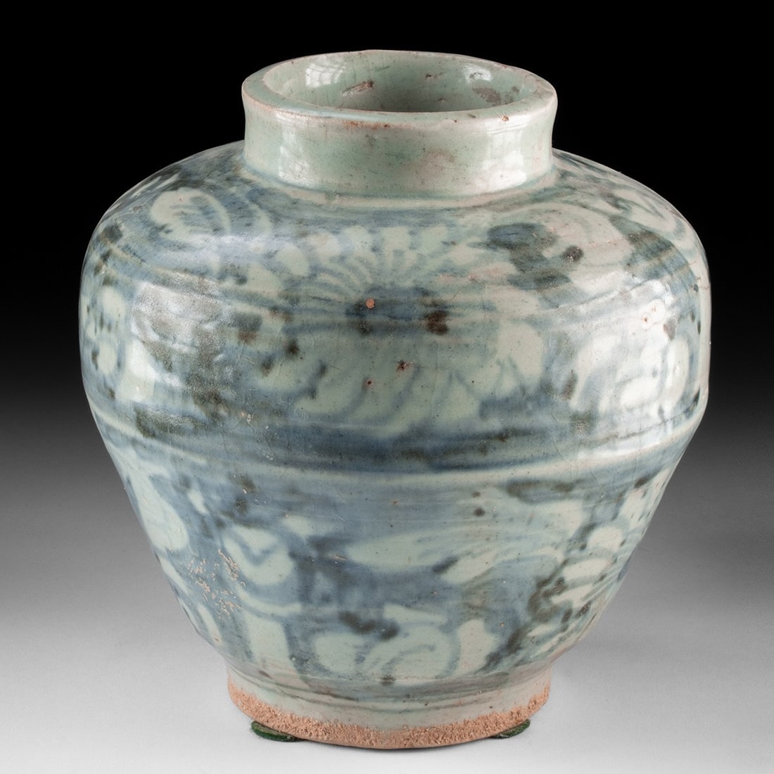 Chinese Ming / Qing Dynasty Blue & White Glazed Jar - Floral Scrolls: East Asia, China, Late Ming to Qing Dynasty, ca. 17th to 19th century CE. A wheel-thrown stoneware jar in the Swatow or Zhangzhou export tradition, with a rounded shoulder, short neck, and unglazed fo