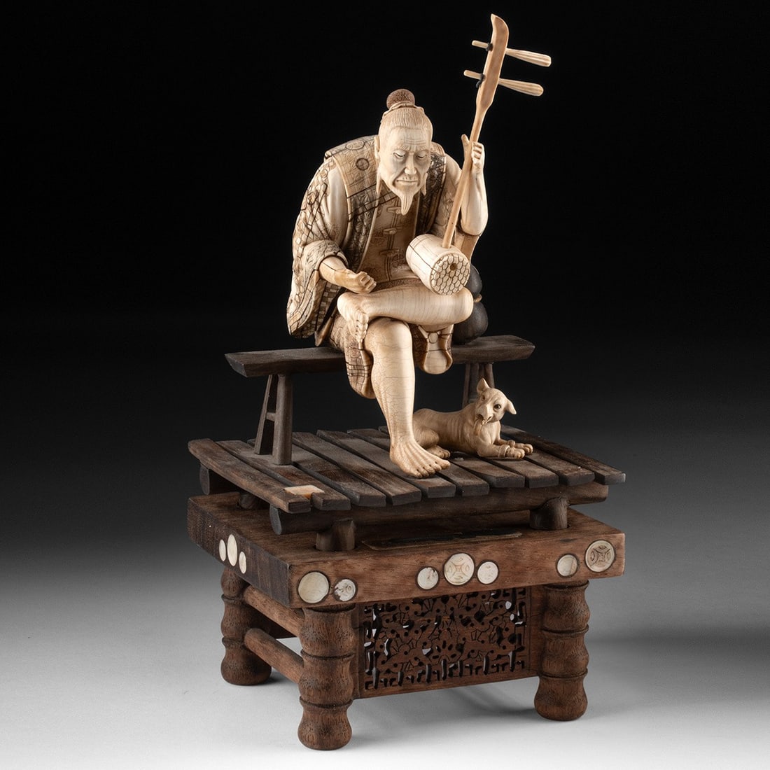 Chinese Mammoth Ivory Erhu Player w/ Dog: Ca. 1912–1970 CE. East Asia, China, Republic to People's Republic period, ca. 1912 to 1970 CE. A seated elder bends over his erhu with the unselfconscious absorption of a man who has long since 