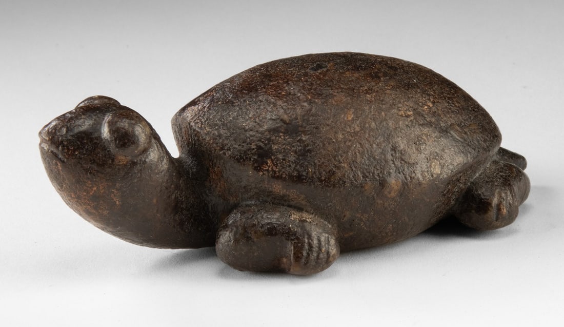 Chinese Archaistic Stone Turtle Carving: Ca. 1934–1967 CE. East Asia, China, ca. mid-20th century CE. A carved stone figure of a turtle with rounded shell and simplified head and limbs, worked in dark brown stone with an intentionally 