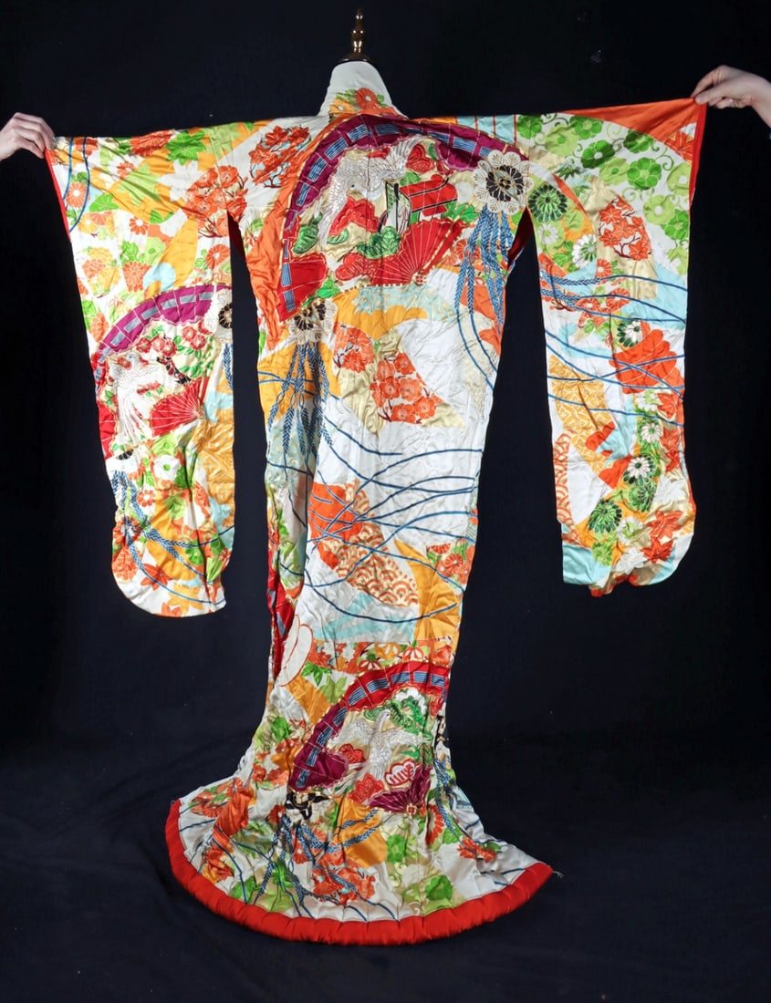 Vibrant Japanese Silk Uchikake Wedding Kimono: Ca. 1934–1967 CE. East Asia, Japan, ca. mid to late 20th century CE. A silk uchikake wedding kimono with extended sleeves, composed in vivid polychrome with painted, dyed, and embroidered decora