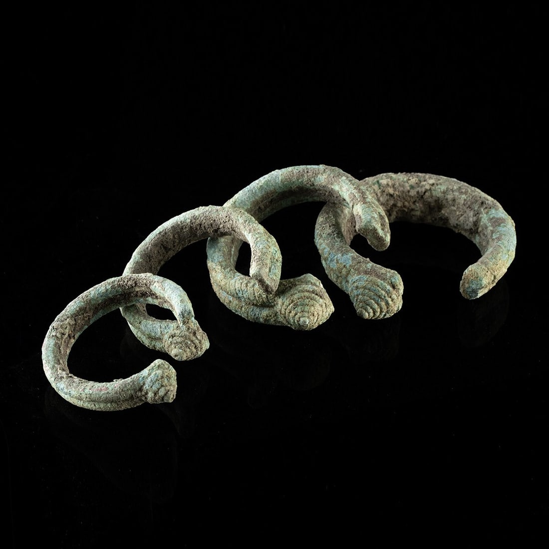 Four Dong Son Graduated Penannular Ornaments: Southeast Asia, Vietnam, Dong Son culture, ca. 700 BCE – 100 CE. A graduated set of four penannular ornaments, each a cast lead-alloy ring drawn into a smooth circular band and left open at one 