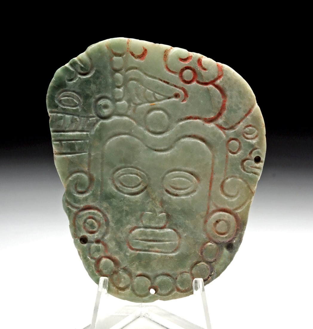 Fine Maya Jade Pendant - Lord's Visage: Ca. 550–900 CE. Pre-Columbian, Maya Territories, Late Classic Period, ca. 550 to 900 CE. An incredible low relief omphacite jade pectoral pendant hand pecked and polished, etched with a lord's v