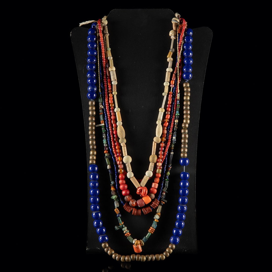 Six 19th C. African & Native American Trade Bead Necklaces - Glass, Stone & Brass: Africa and North America, Indigenous tribes, ca. 1800–1975 CE. A group of six strands assembled from the polyglot currency of the bead trade: heavy cobalt glass rounds of Padre type, long files 