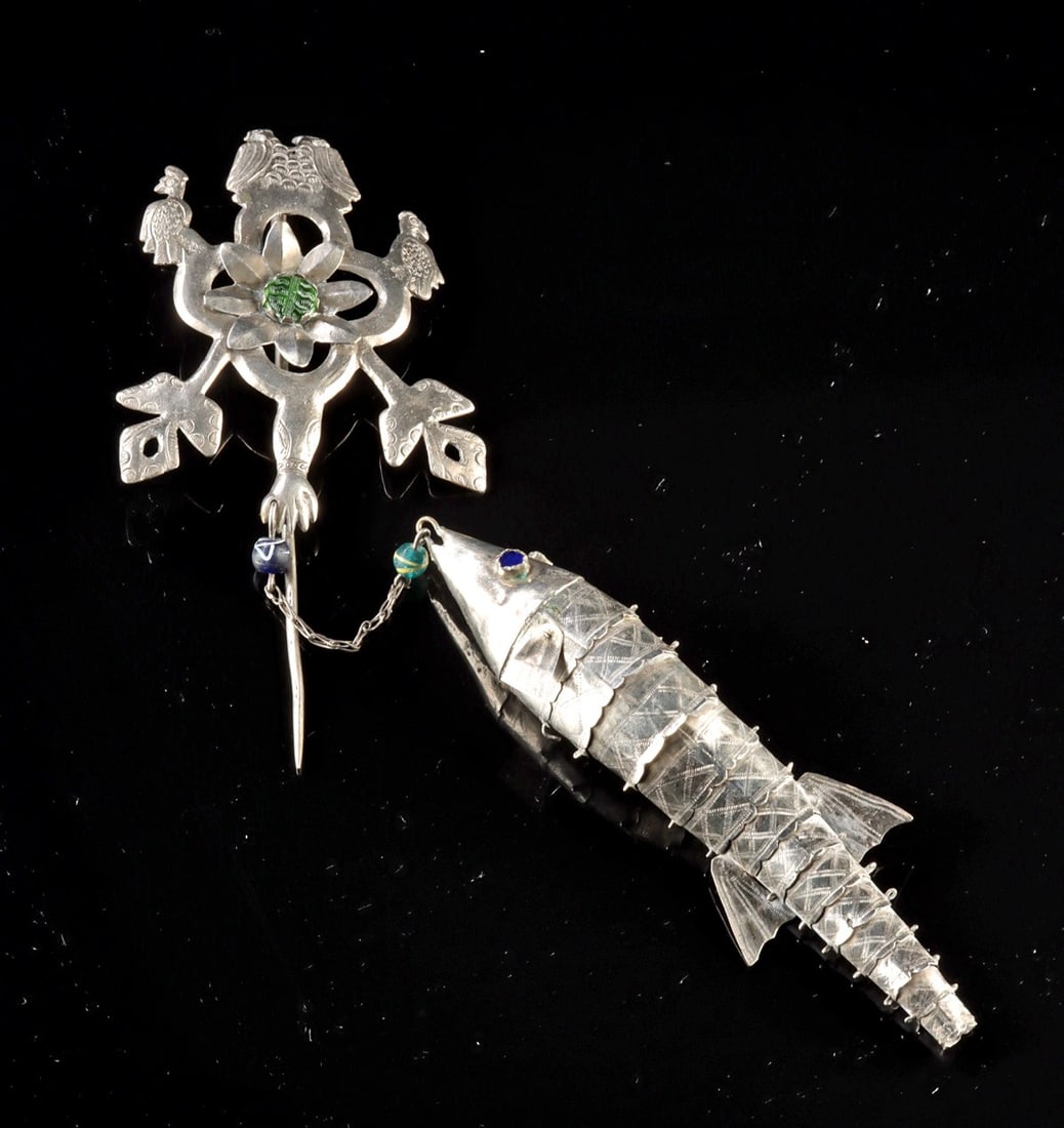 Andean Silver Tupu Pin - Fish & Peacock Pendant: Ca. 1900–2000 CE. South America, Andean region, ca. 20th century CE. A lively 20th century Andean silver tupu pin featuring a finely worked articulated fish pendant and a stylized peacock-form h