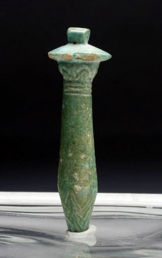 Lg Egyptian Faience Papyrus Amulet: Egypt, Late Period, ca. 500 BCE. A long aqua-marine faience pendant in shape of a papyrus with pointed end, tapered shaft, wide rim and mounting staple. Incised triangular design on tip and below rim.