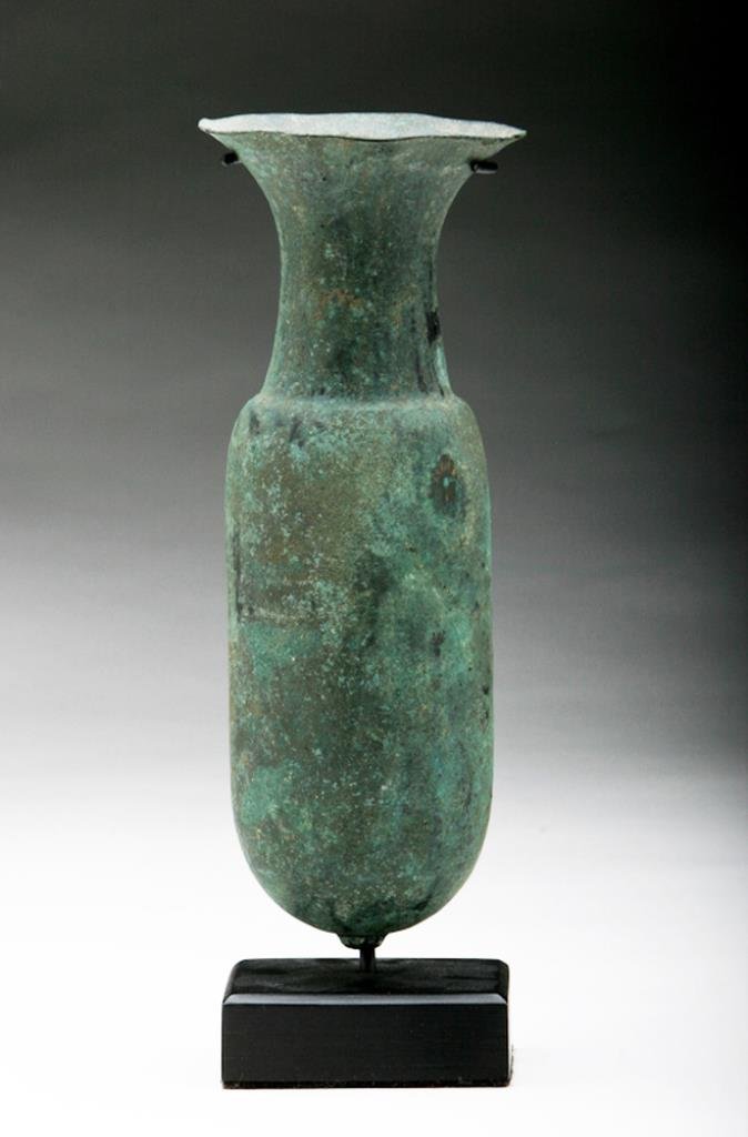 Luristan Bronze "Amphora" Vase: Luristan, ca. 1000 - 800 BCE. A beautifully crafted bronze vase, being hammered rather than cast. The vase is formed in the style of an amphora, with an elongated cylindrical body rising over a button