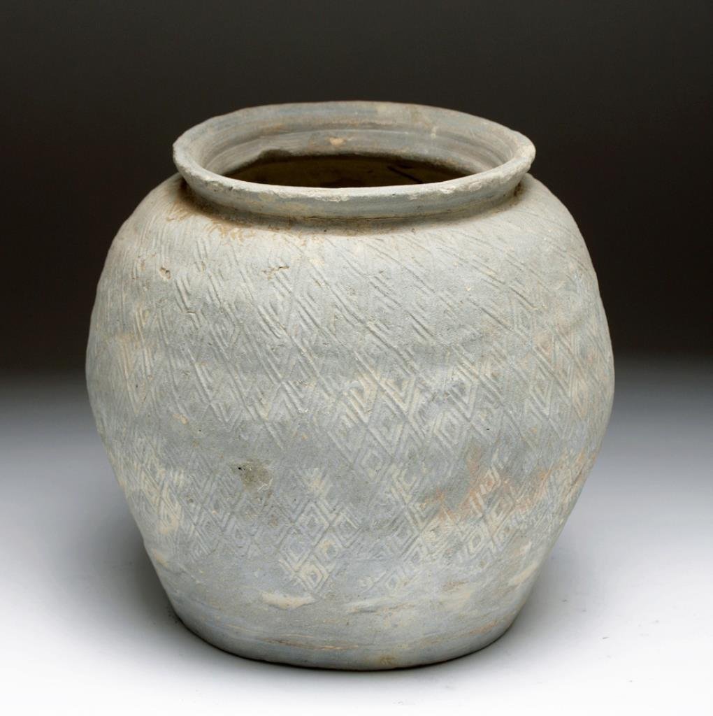 Chinese Han Dynasty Greyware Vessel: China, ca. 206 BCE - 220 CE. A greyware terracotta jug with net pattern impressed into side of amphora. Flat base tapers out to a low shoulder, and back in to a flared rim. Terracotta slipped in grey