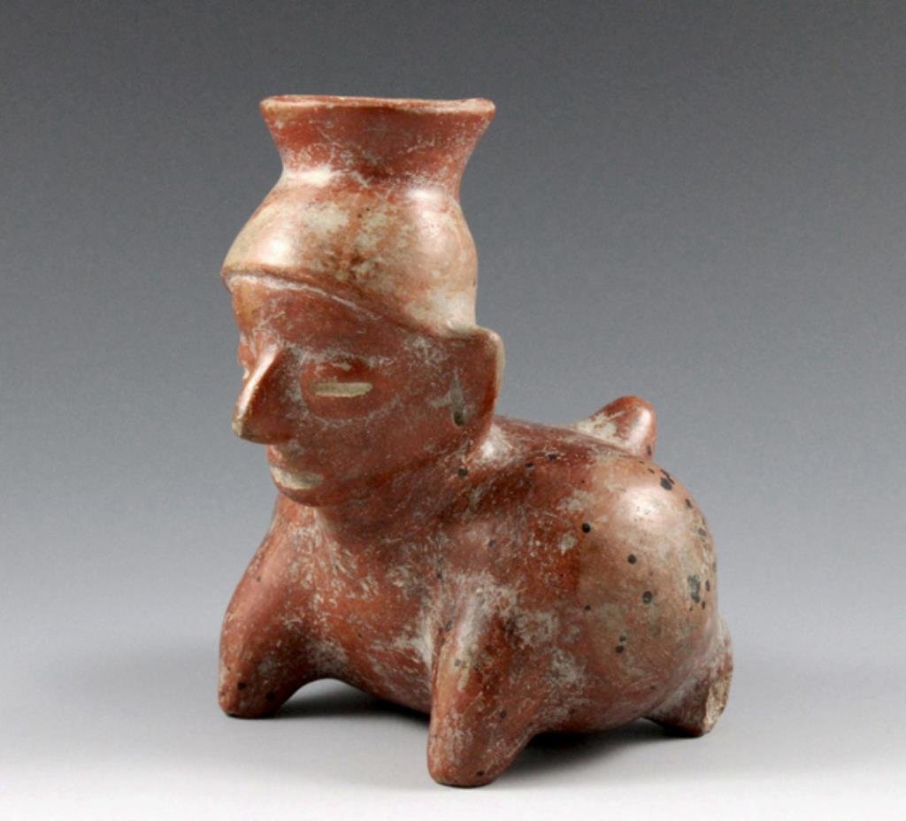 Pre-Columbian Colima Figure - Man / Dog Transformation: From the ancient Colima region of West Mexico, ca. 200 BCE - 200 CE. Terracotta figural vessel depicting a half-human, half-dog individual. This likely represents a shaman in symbolic transformation i