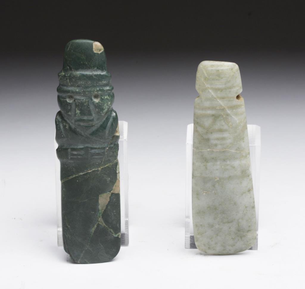 Lot of 2 Costa Rican Jadeite Axe Gods: Pre-Columbian, Guanacaste / Nicoya region, ca. 200-600 CE. Lovely pair of carved jadeite celts, one a deep shade of green, the other in a contrasting light shade. Both are incised with stylized anthro