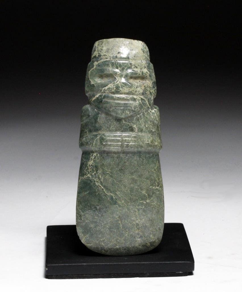 Pre-Columbian Costa Rican Axe God Celt: Guanacaste / Nicoya region, Costa Rica, 200-600 CE. This anthropomorphic figure with hands across the chest is finely carved from jadeite. It is pierced at the neck to be worn as a pendant. Costa Rica