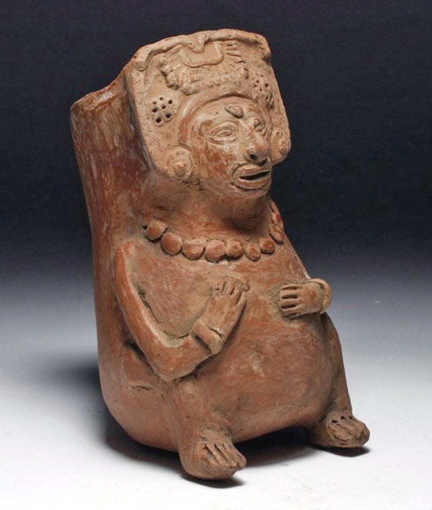 Mayan Figural Effigy Vessel - Seated Lord: Pre-Columbian, Maya Culture, ca. 600 - 900 CE. A Mayan effigy vessel in the form of a seated lord. Lord is wearing an ornate headdress, large beaded necklace, and bracelets. Incised facial, finger, an
