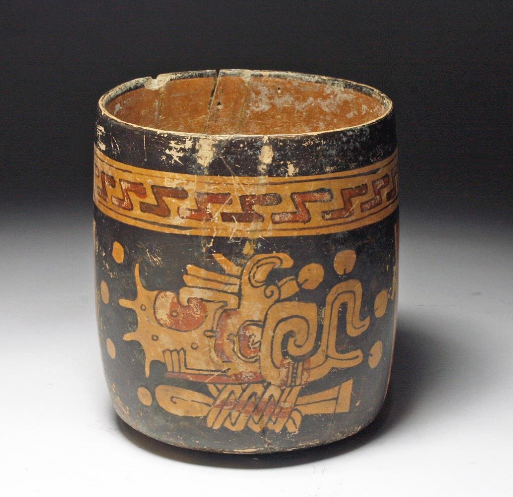 Maya Polychrome Short Cylinder: Mayan territories, most likely Honduras, ca. 500 to 800 CE. Vivid Mayan cylinder vessel painted on each side with abstract underworld scene in orange against a black background - band of "z's" across 