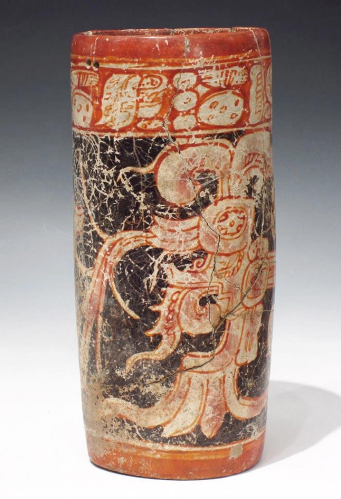 Large Vibrant Mayan Cylinder - Chac-Mool: Mayan territories, Guatemala, ca. 500 to 800 CE. Tall and thin polychrome cylinder decorated with two identical, polychrome scenes. Depicted in profile is the head of the mythical Och Chan, the Bearde