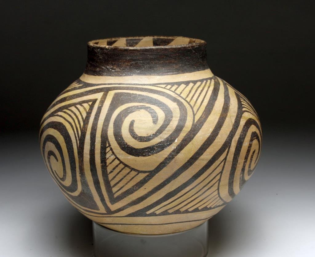 Casas Grandes Round-Bottomed Vessel: Northern Mexico, ca. 1250-1475 CE. The exquisite abstract spiral parrot eye motifs framed by stylized linear motifs wrap this gorgeous vessel. In addition to the refined painting on the surface, the w