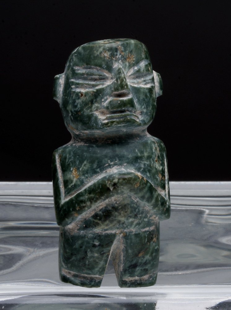 Solemn Mayan Jadeite Figurine: Valley of Mexico, Tlatilco, ca. 1200-200 BCE. This exquisitely crafted worshipper clasps his hands together and closes his eyes facing upward in a gesture of prayer or an intranced state in communion 