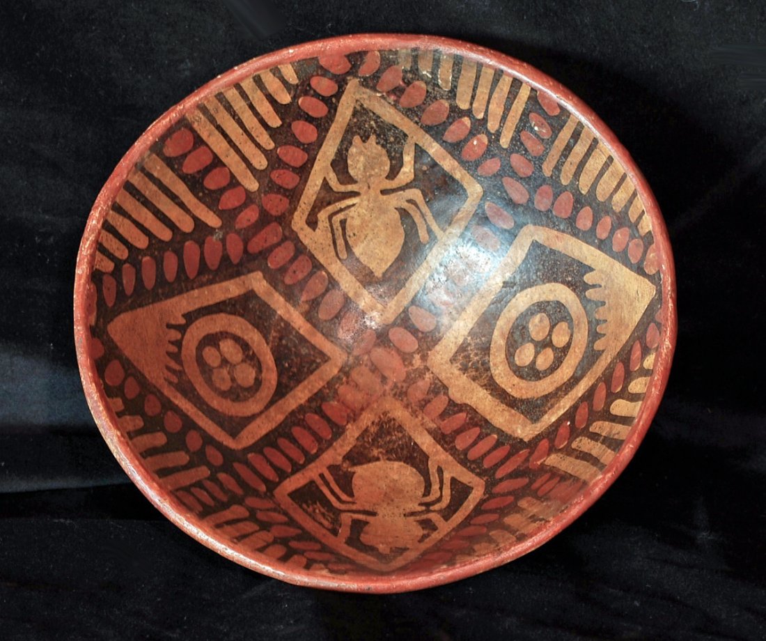 Pre-Columbian Narino Bowl with Spiders: This ornately decorated Narino bowl of Colombia is remarkable for its rich and unusual iconographical program. Segmented into four discrete diamond-shaped areas, we have the negative silhouettes of sp
