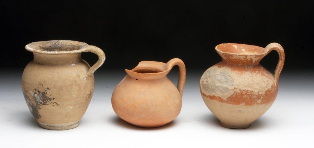 Lot of 3 South Italic Terracotta Vessels, Ex-Farwell: Southern Italy, ca. 5th - 4th century BCE. Set of three terracotta single handled vessels, one redware vessel, one bi-chrome olpe with flared rim, and a black-slipped pitcher. 3" to 3-3/4"H. Provenanc