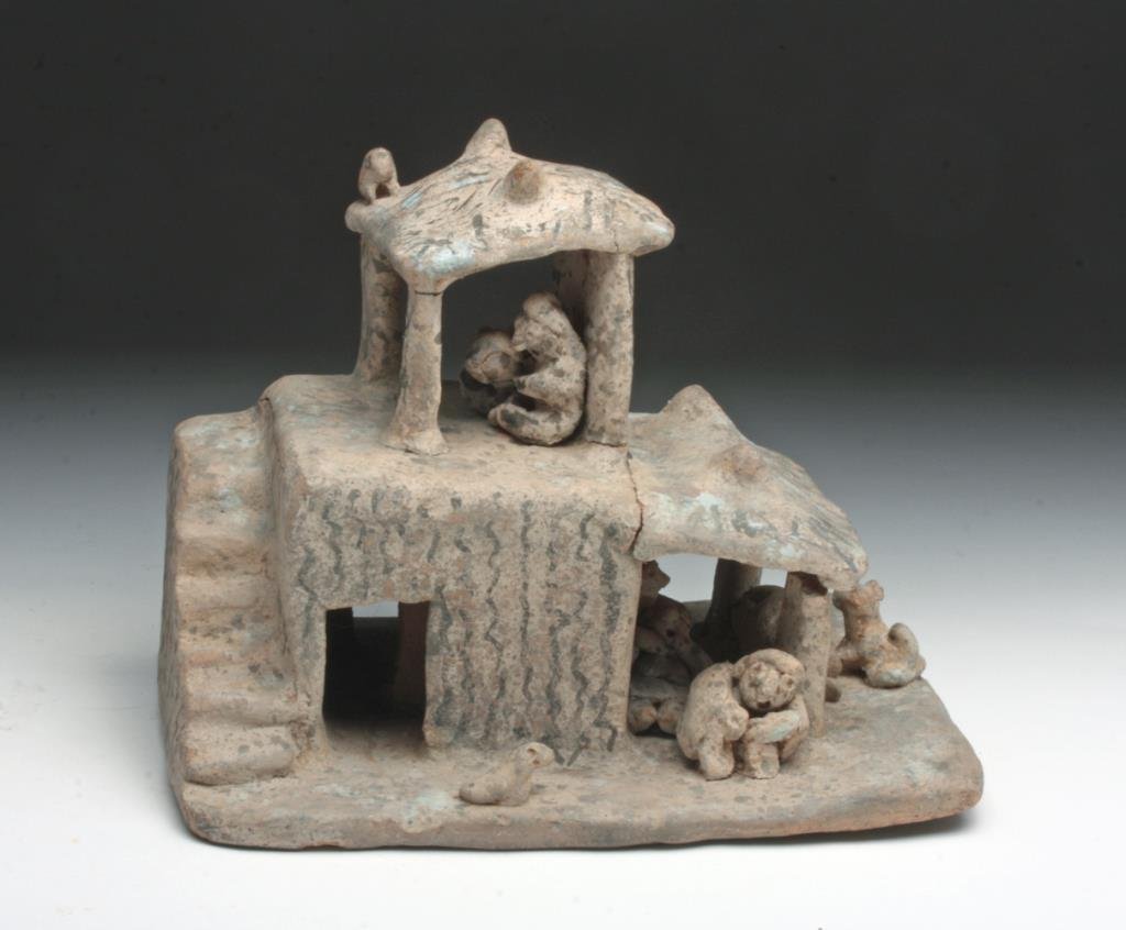 Miniature Pre-Columbian Maquette (House and People): Mexico, Nayarit, Proto-Classic, ca. 300 BCE to 300 CE. This earthenware maquette depicts a miniature house with a group of people inside of it. The ground floor includes a 'room' that was used to stor