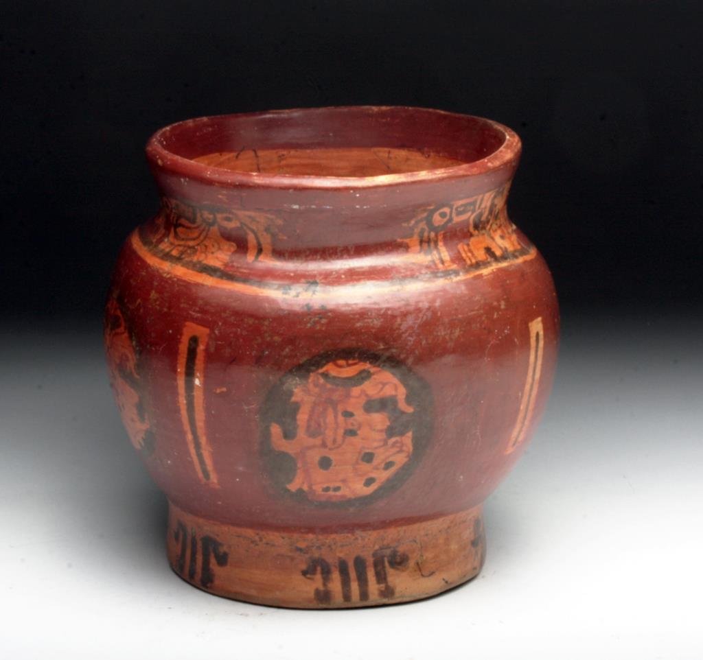 Mayan Polychrome Footed Olla: Pre-Columbian, Maya, Ulua Valley of Honduras, Ca 500 to 90 CE. Stunning polychrome olla with bulbous midsection, short painted foot and slightly flared rim; painted in a deep-red base with three panel