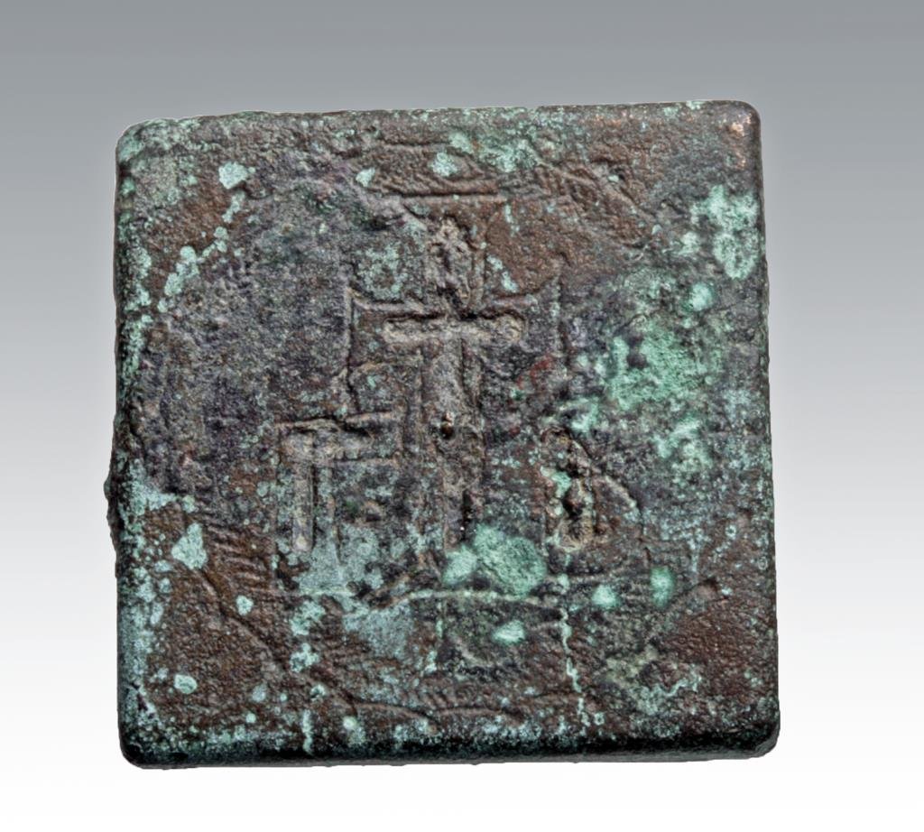 Late Roman / Byzantine Bronze Square Token - Crucifix: Late Roman Period to Byzantine, 4th - 10th century CE. A cast bronze square token with incised image of the crucifix on front. Possibly mounted in wall with similar images. 1-1/8" x 1-1/8". Provenance