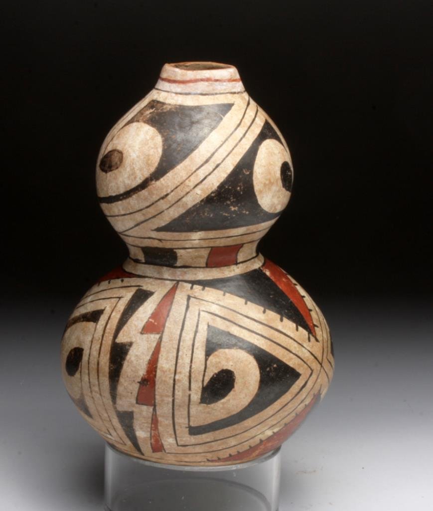 Casas Grandes Polychrome Double Built Vessel: Northern Mexico, Casas Grandes, ca. 1250-1475 CE. This unusual double-built, round-bottomed form features red and black slip-painted ornamentation on cream ground on all external surfaces of the pot, 