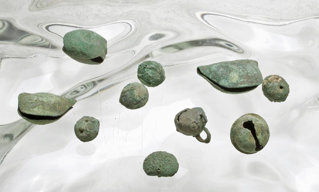 Lot of 10 Ancient Peruvian Copper Bells: Pre-Columbian, likely Inca, ca. 1000-1500 CE. Group of ten copper bells of various shapes and sizes. Some still produce sound. Most have loops or perforations for suspension. Gorgeous patina. Range in