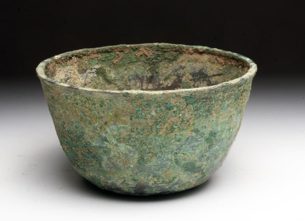 Large Khmer Cambodian Bronze Bowl: Khmer, Cambodia, Ca. 12-14th Century CE. A large bronze bowl of high tin content with five parallel lines encircling the bowl just under the rim. Bowl has small indention on base. Bronze has developed