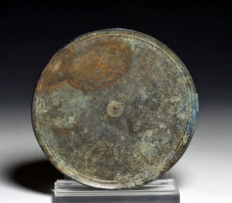 Khmer Bronze Mirror - Azurite Deposits: Cambodia, Ca 1000 to 1200 CE. Cast bronze mirror of simple form with small incised circles on one side, silver applied to the other. Over the nearly 1000 years of burial, the silvered side has lost mu