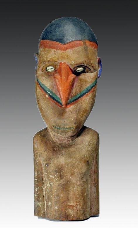 Polynesian Polychrome Carved Wood Tiki Figure: Polynesia, 20th Century. A carved wood Tiki figure with inlaid shell eyes, orange painted nose, black hair, open mouth with incised teeth and green tongue, and carved ears that are painted blue. 16"H.