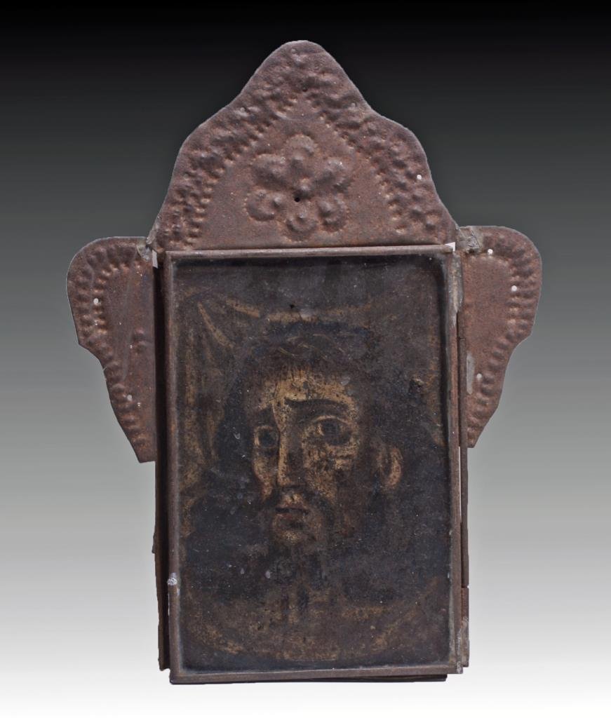 Antique Mexican Nicho Box - Mournful Christ: Mexico, ca. 1800 CE. A lovely little tin nicho box enclosing a painted metal picture of the Christ. He wears a crown of thorns on his head, his eyes large and mournful, his dark hair billowing around 