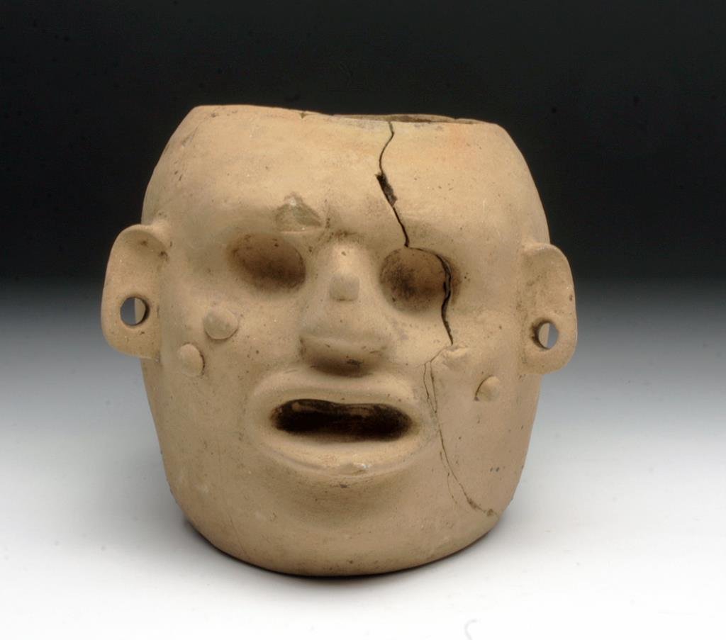 Expressive Mayan Head Vessel: Pre-Columbian, Mexico, Tabasco, ca. 400 to 900 cue. This lively hand built vessel in the form of a human head features an expressive wart-covered face. The Maya were preoccupied with health, and medic