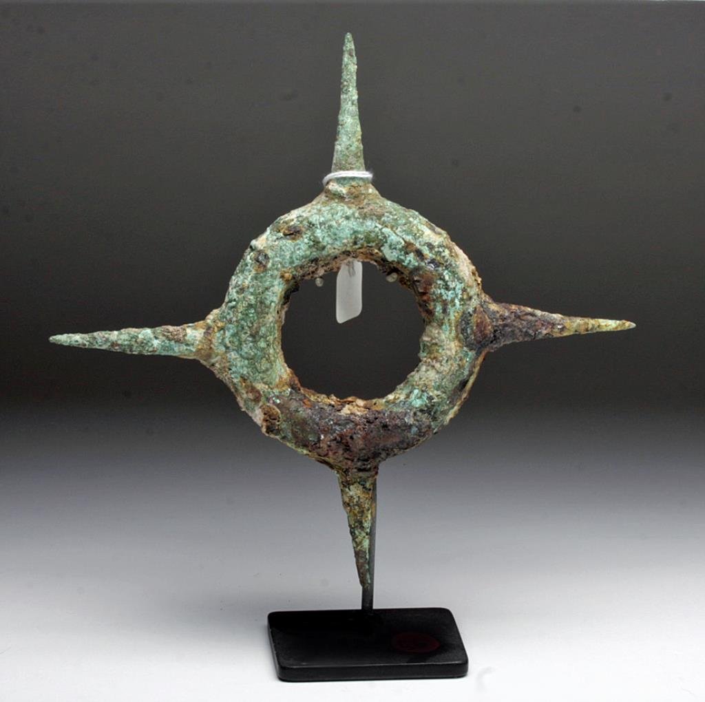Thai Ban Chiang Bronze Bracelet: Southeast Asia (Cambodia, Thailand), ca. 300 BCE – 200 CE. Round bronze ornament designed with pain in mind; with open center, outer edge decorated with series of four quite pointy spikes intended f