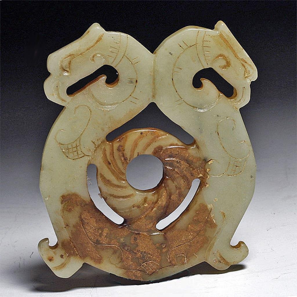 Chinese Jade Pendant, Double Bird Heads: China, Qing Dynasty to early Republic period, ca 1900 to 1925 CE. Carved "mutton fat" jade plaque with opposing double bird heads (phoenix perhaps?), each head with large beak and incised decorations