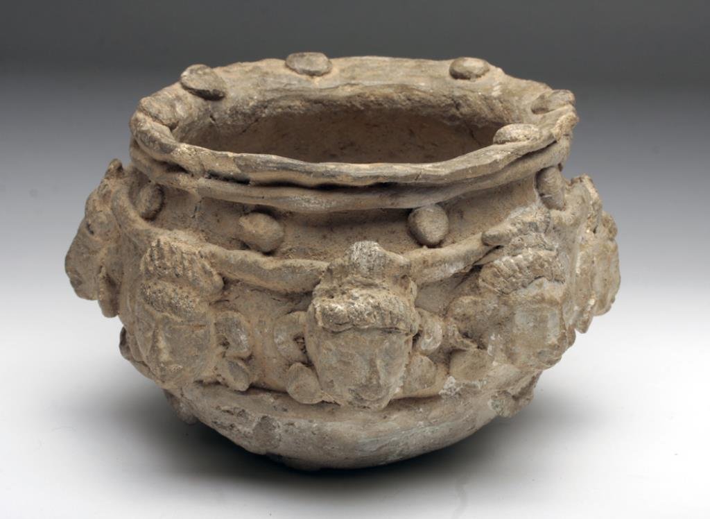Mayan Terracotta Jar, Ex-Christian Rub: Mexico, Mayan Territories, ca. 550 - 950 CE. This intriguing terracotta bowl is adorned with an ensemble of eight human visages all elaborately adorned with fanciful coiffures/headdresses and prominen