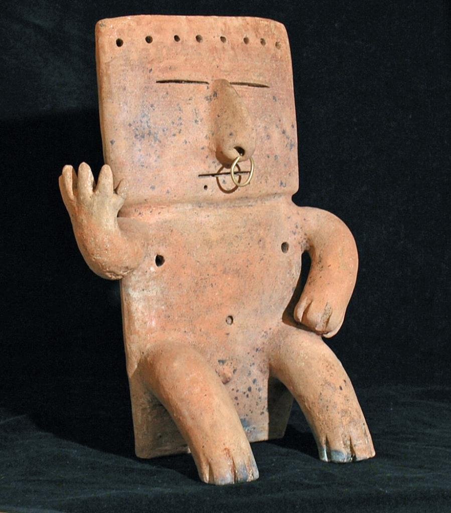 Pre-Columbian Quimbaya Retablo: Colombia, ca. 1200-1400 CE. A handsome Retablo figure, solid ceramic, with remnants of negative resist paint application. An outstanding example. 12" x 9-1/2" Provenance: Ex Walter Avoss collection, S