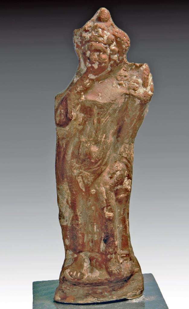 Egyptian Terracotta Harpokrates: Egypt, ca. 1st - 3rd century CE. An ancient pottery statuette of the child god Harpokrates, his right to his mouth, a cornucopia in his left hand. 5-1/4"H (13 cm). Provenance: Formerly in the M. Carvi