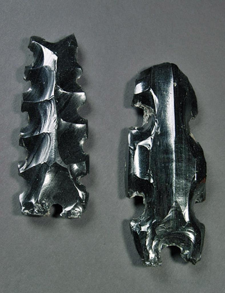 Lot of 2 Mayan Obsidian Figurative Forms - Centipede,: Pre-Columbian, Maya, Central Lowlands, Classic Period, ca. 300 - 800 CE. Translucent deep gray obsidian (obtained from Guatemala Highlands). Two large showy examples of the lithic eccentric tradtiond