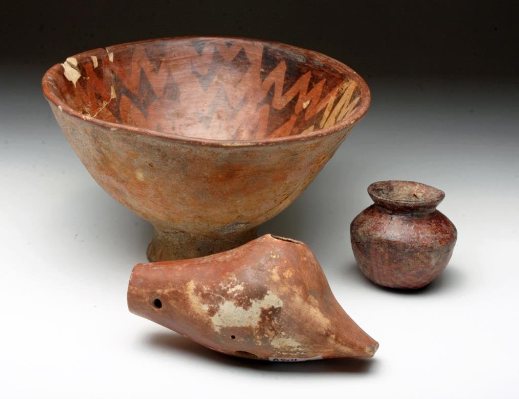 Lot of 3 Narino Redware Pottery Vessels: Pre-Columbian, Border Ecuador / Columbia, Narino culture, ca. 800-1500 CE. This ensemble includes a striking bowl with pedestal base and an impressive form as well as a stylized radiating concentric s