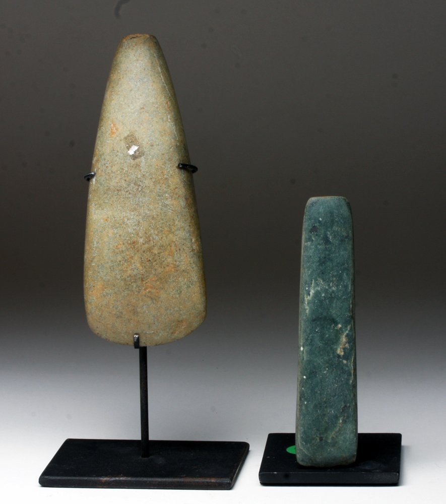 Pair of Mayan and Proto-Mayan/Olmec Ceremonial Celts: Pre-Columbian, Mayan territories, Mayan, ca. 550 CE - 800 CE and Proto-Mayan possibly Olmec, ca. 1000 BCE - 550 CE. This pair of stone celts includes a Mayan example, the larger piece, as well as a pr