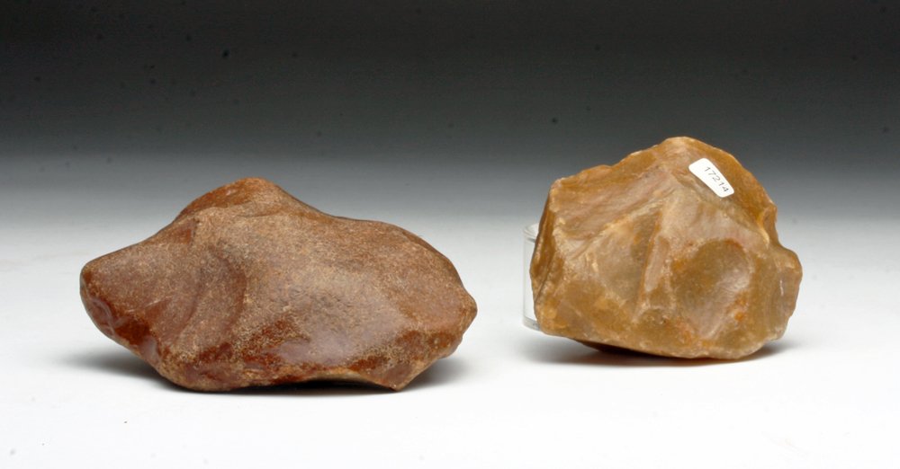 Pair of Neanderthal Hand Axes: Europe, ca. 70,000 years ago. A pair of napped stone tools, a large hand axe or hoe, the second a thoughtfully designed blade with sharp edges. 6-1/2"L & 4-1/2"L. Provenance: Ex-Connell Collection, MA
