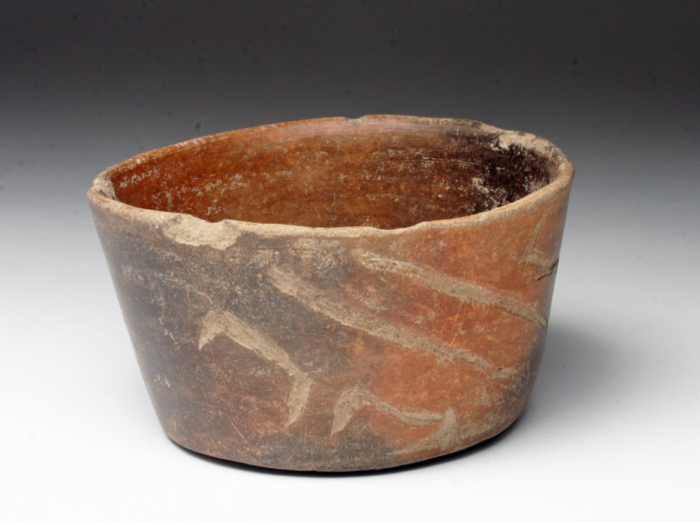 Early Pre-Columbian Olmec Blackware Bowl: Mexico, Olmec, 1000-800 BCE. Blackware pottery bowl with straight walls, misfired so it appears in two tones of black and brown, with simple incised geometric design. 4"D x 1-3/4"H. Provenance: Ex-pri